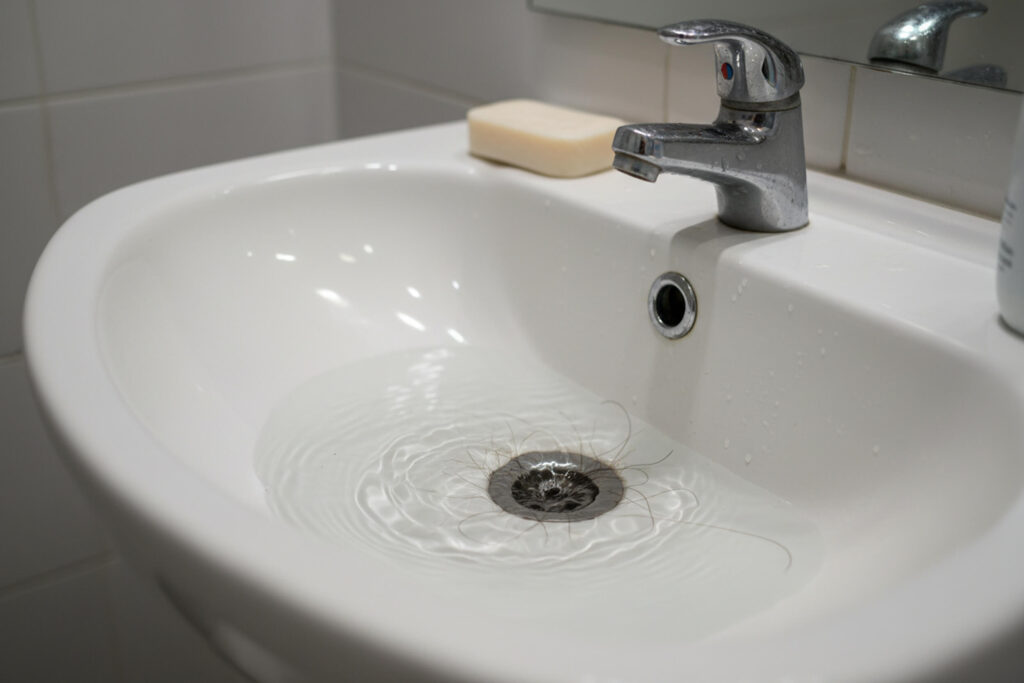 Slow draining sink with visible water pooling