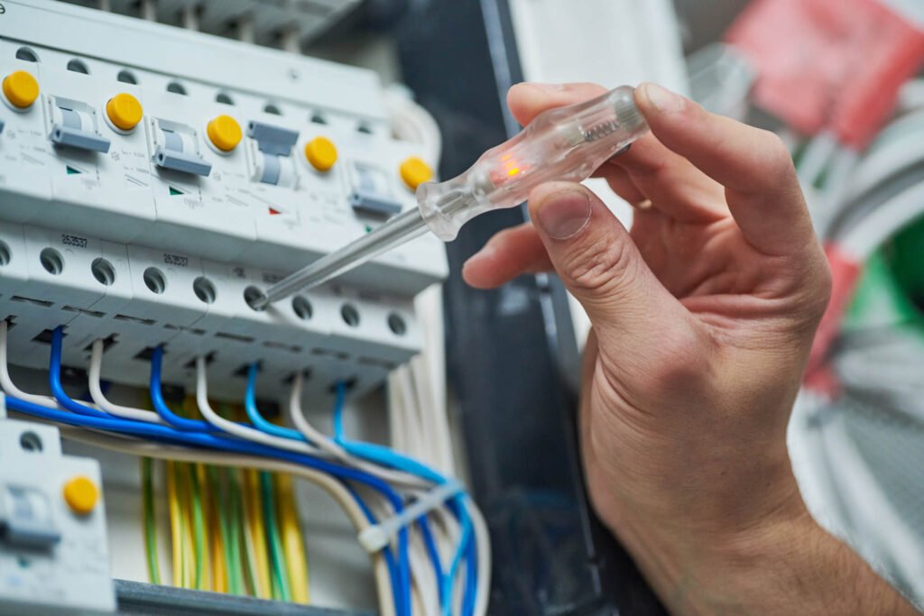 electrician works on switchboard