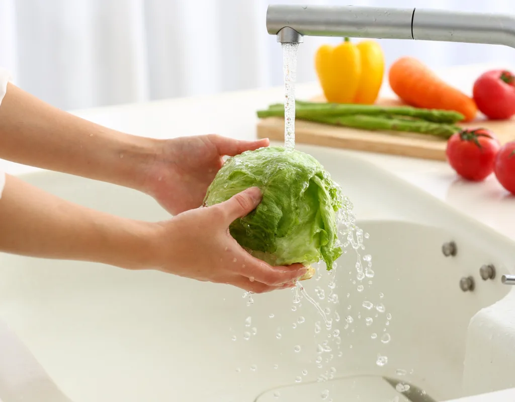washing lettuce in kitchen sink